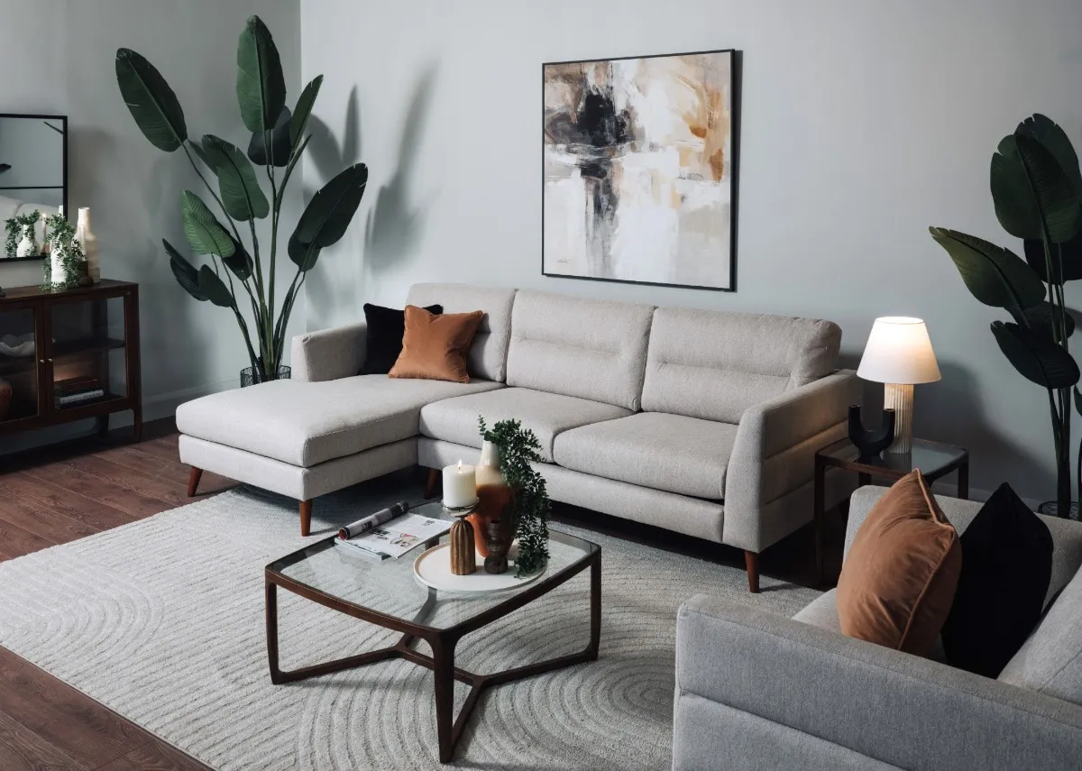A lifestyle image of the Presley beige corner chaise with cameo table and evocative canvas
