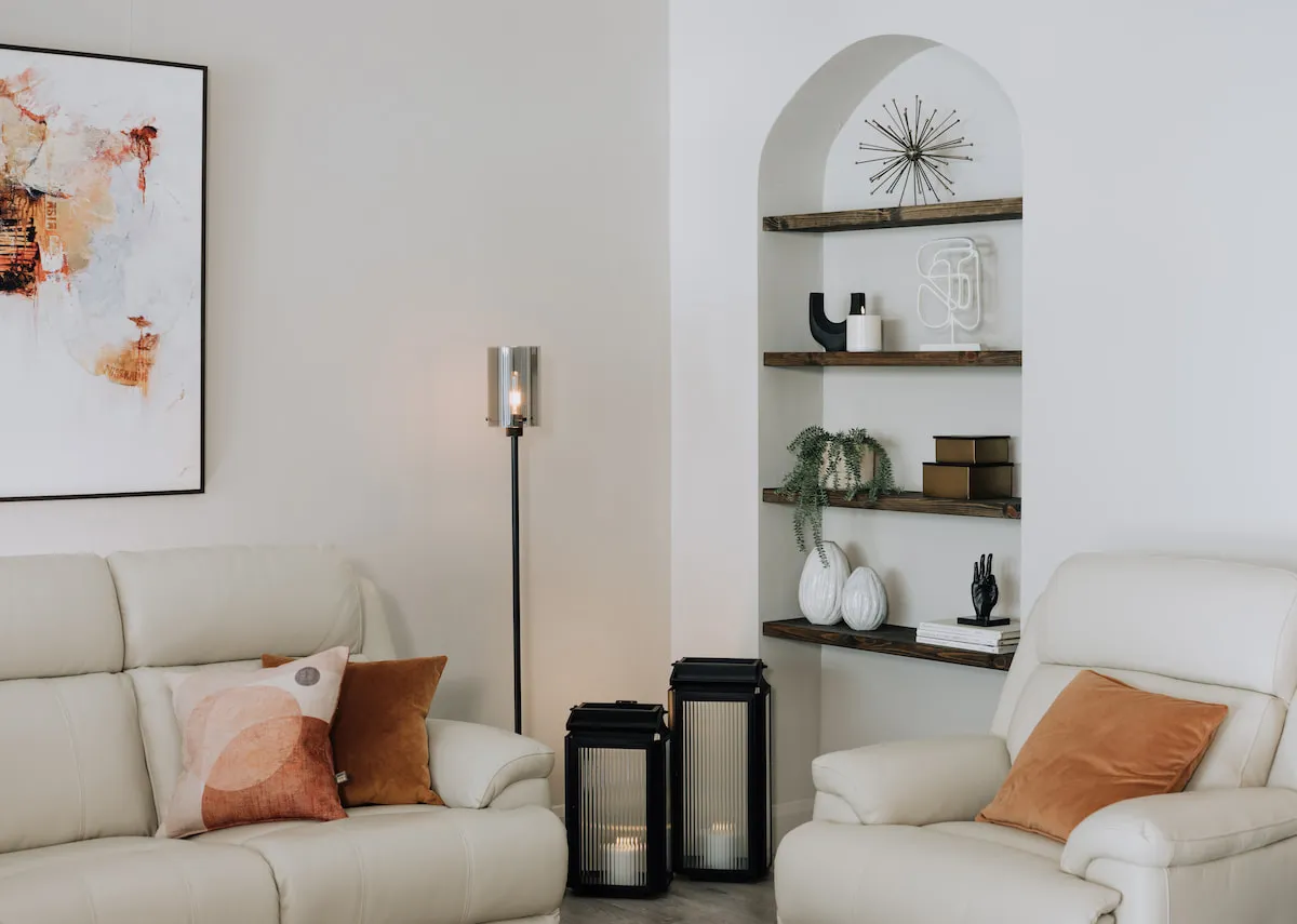 A lifestyle image of a white living room with alcove and 2 ellis lanterns with Karina floor lamp.