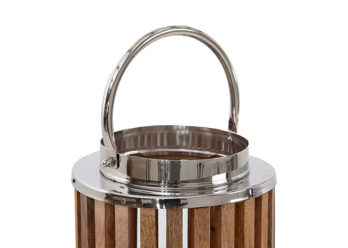 A cylindrical wooden lantern with metal handle from EZ Livings Finley range. Closeup of silver handle