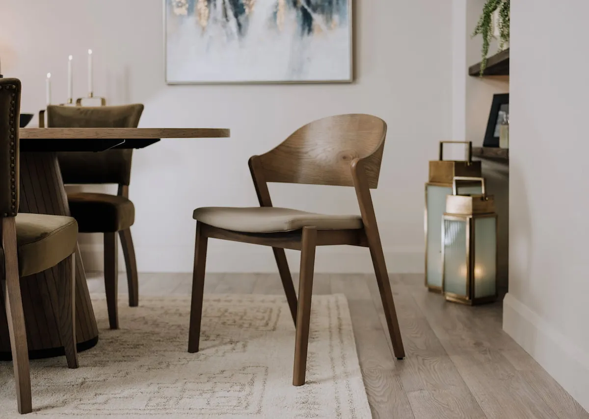 A lifestyle image of the Vega dining chair with Dalia lantern