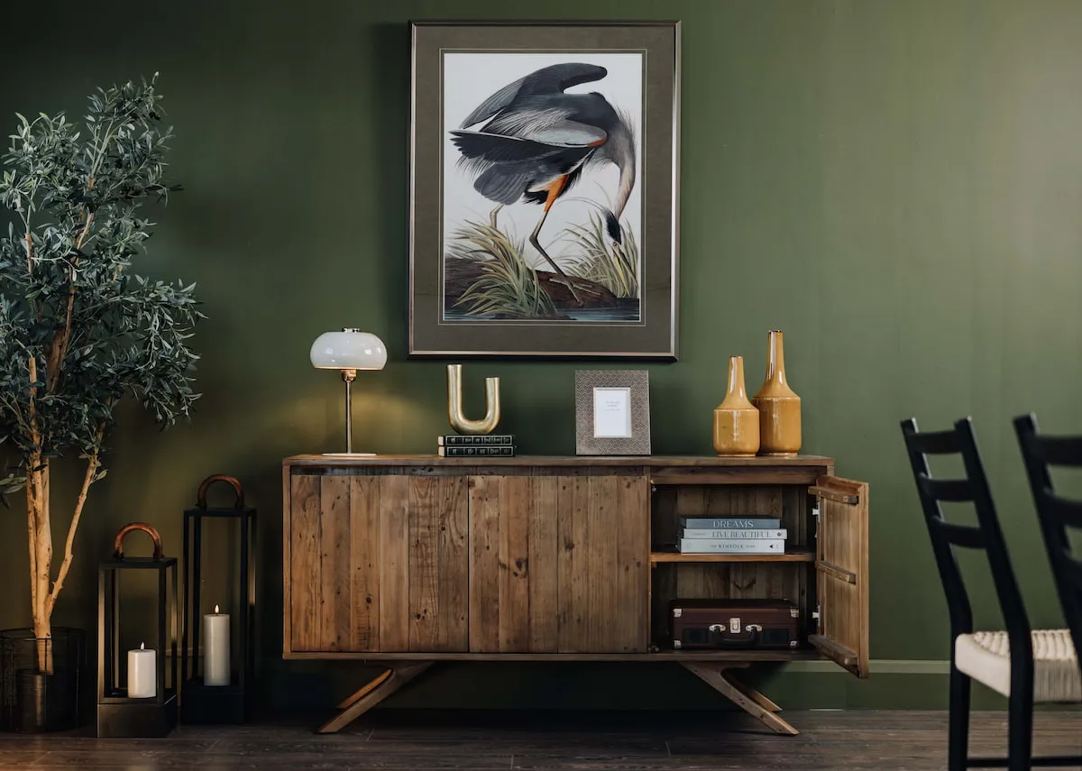 A lifestyle image of the Albion sideboard with end door open showing storage with Blue Heron picture
