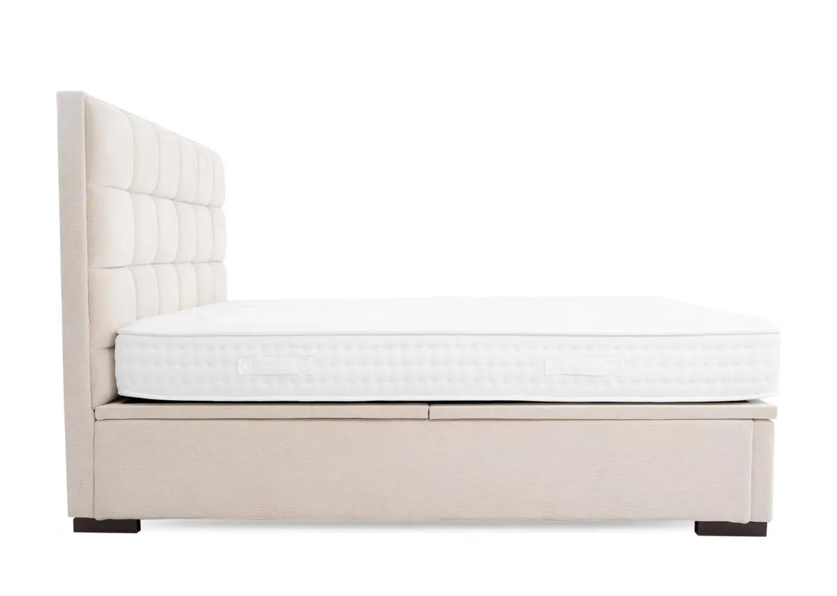 A beige ottoman bed from EZ Livings Sadie Range. Angled view of bed open revealing storage space.