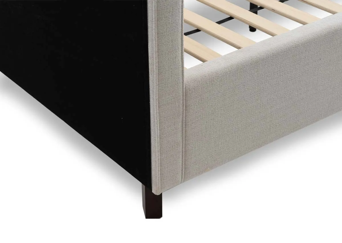 A beige fabric bed frame from EZ Livings Archie range. Closeup of walnut feet
