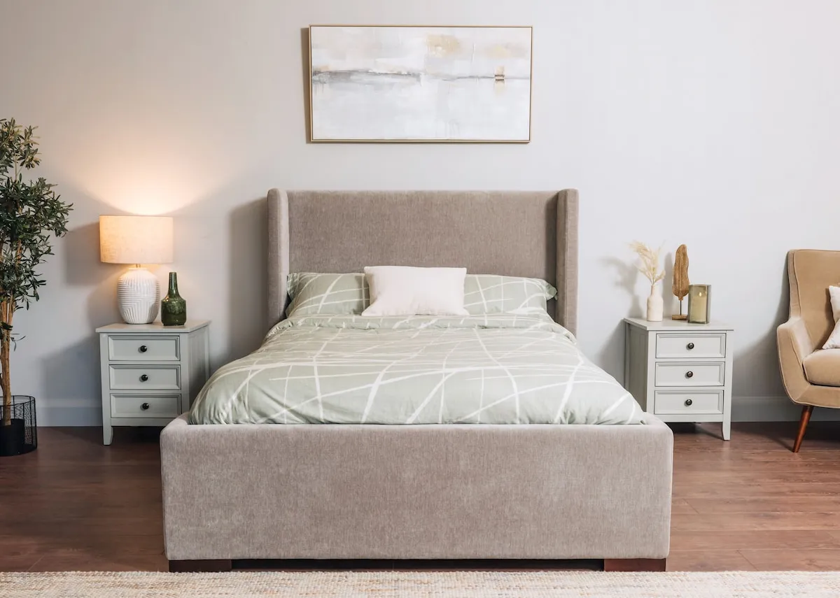 A lifestyle image of the Quaywest Bedframe with Atlas chest and lockers in green ad lakeview canvas.