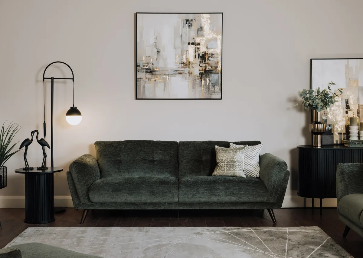 A lifetsyle image of the Toscana green sofa with Lifted canvas pics and Nola side table and casper lamp.