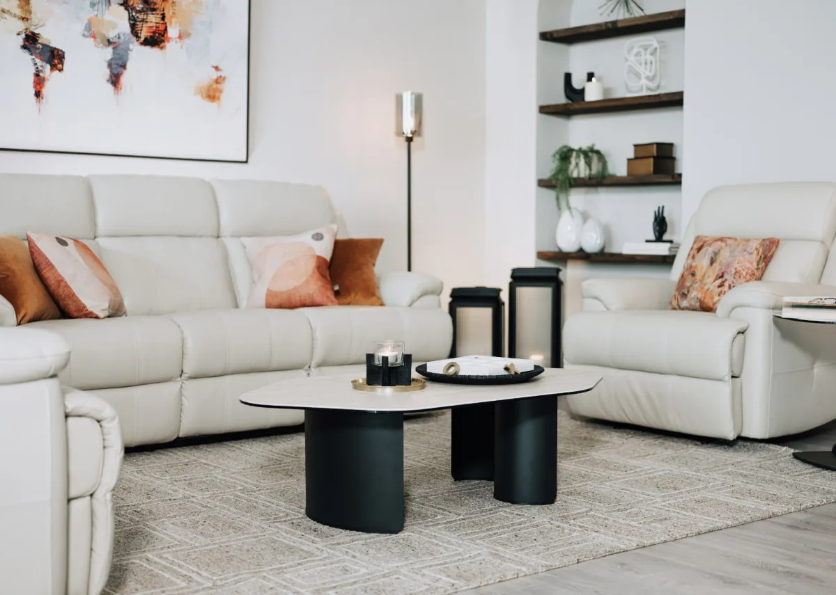 A lifestyle image of the Tempo coffee table with Embrace sofas and Karina floor lamp.