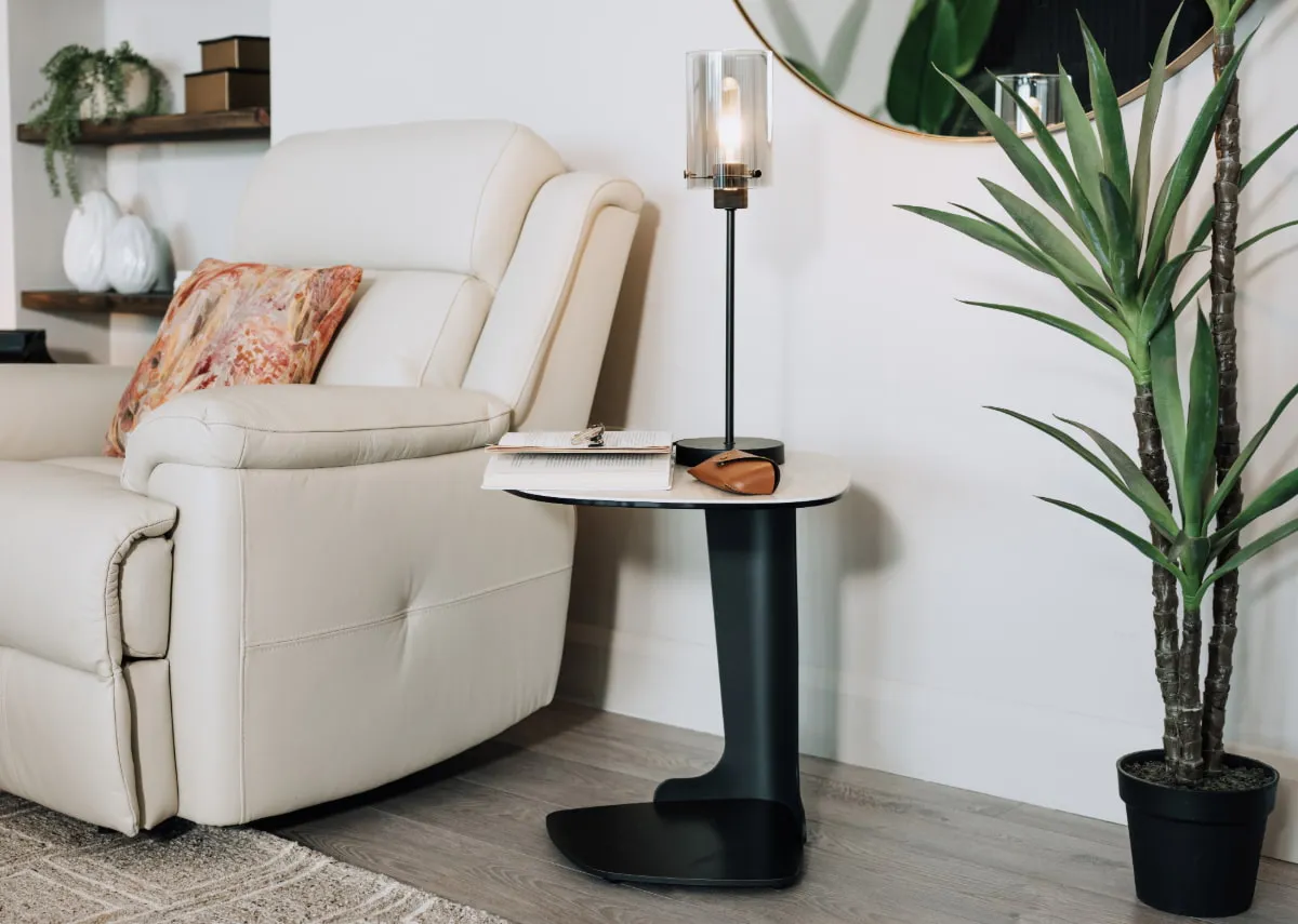 A lifestyle image of the Tempo sofa table with Karina gold table lamp and Yucca plant pot.