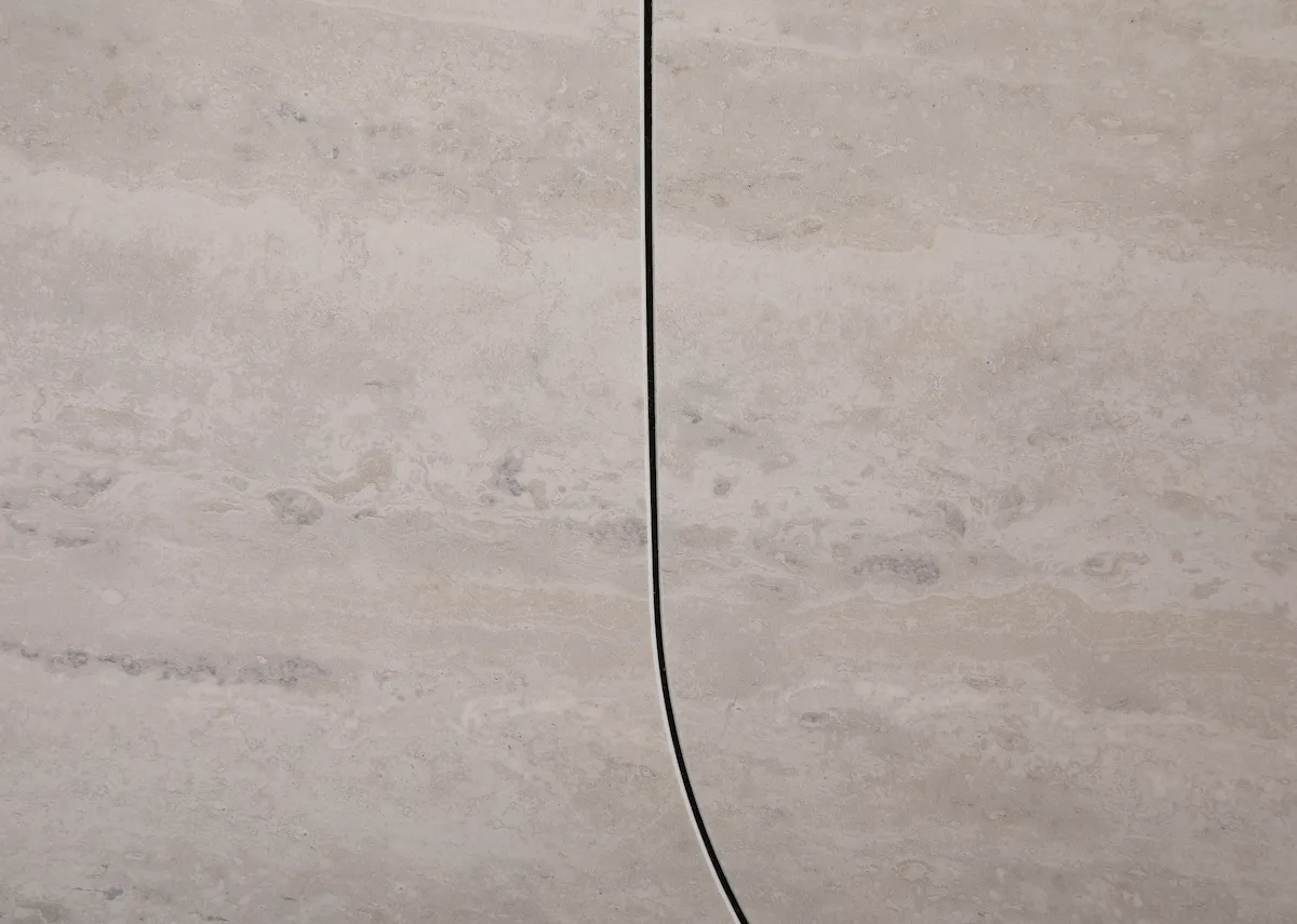 A ceramic top and metal frame dining table from EZ Livings Tempo Range. Closeup of extension leaf closed