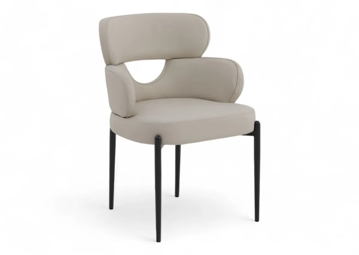 An off white leather dining chair with metal legs from EZ Livings Fusion range. Angled view of the curved back