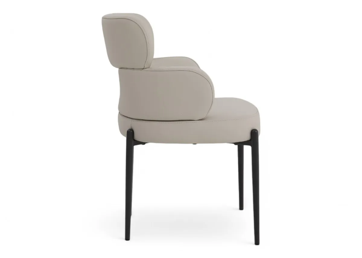 An off white leather dining chair with metal legs from EZ Livings Fusion range. Side veiw of curved back
