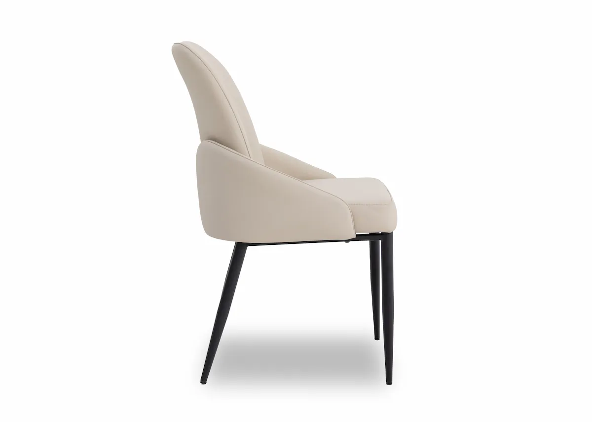 A white faux leather dining chair from EZ Livings Tempo Range. Side view of winged seat