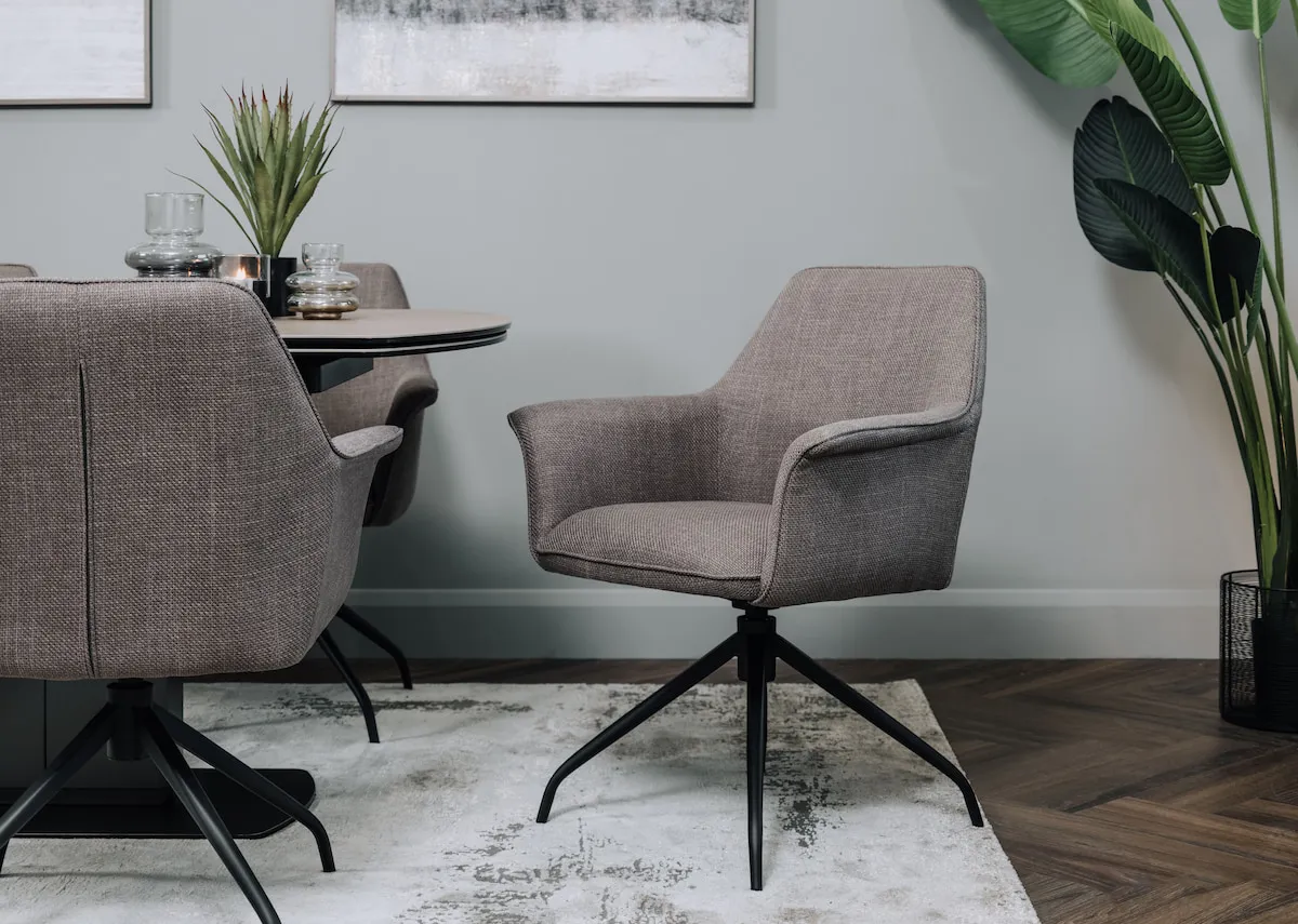 A lifestyle image of the Alor coffee dining chair with swivel base with the Alor dining table