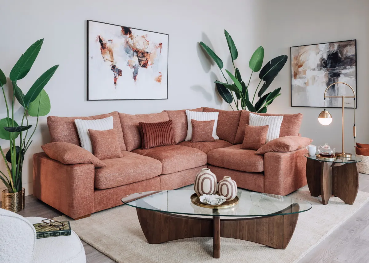 A lifestyle image of the Atrium Coffee Table with Gracie corner sofa and Worldwide canvas.