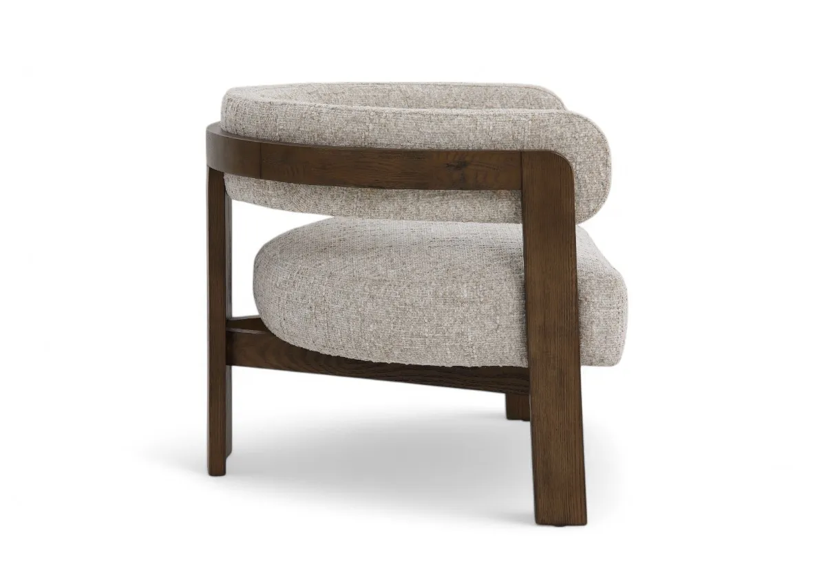 A curved rich oak accent chair with beige seat and backrest from EZ Livings Noma range. Side view of curved seat
