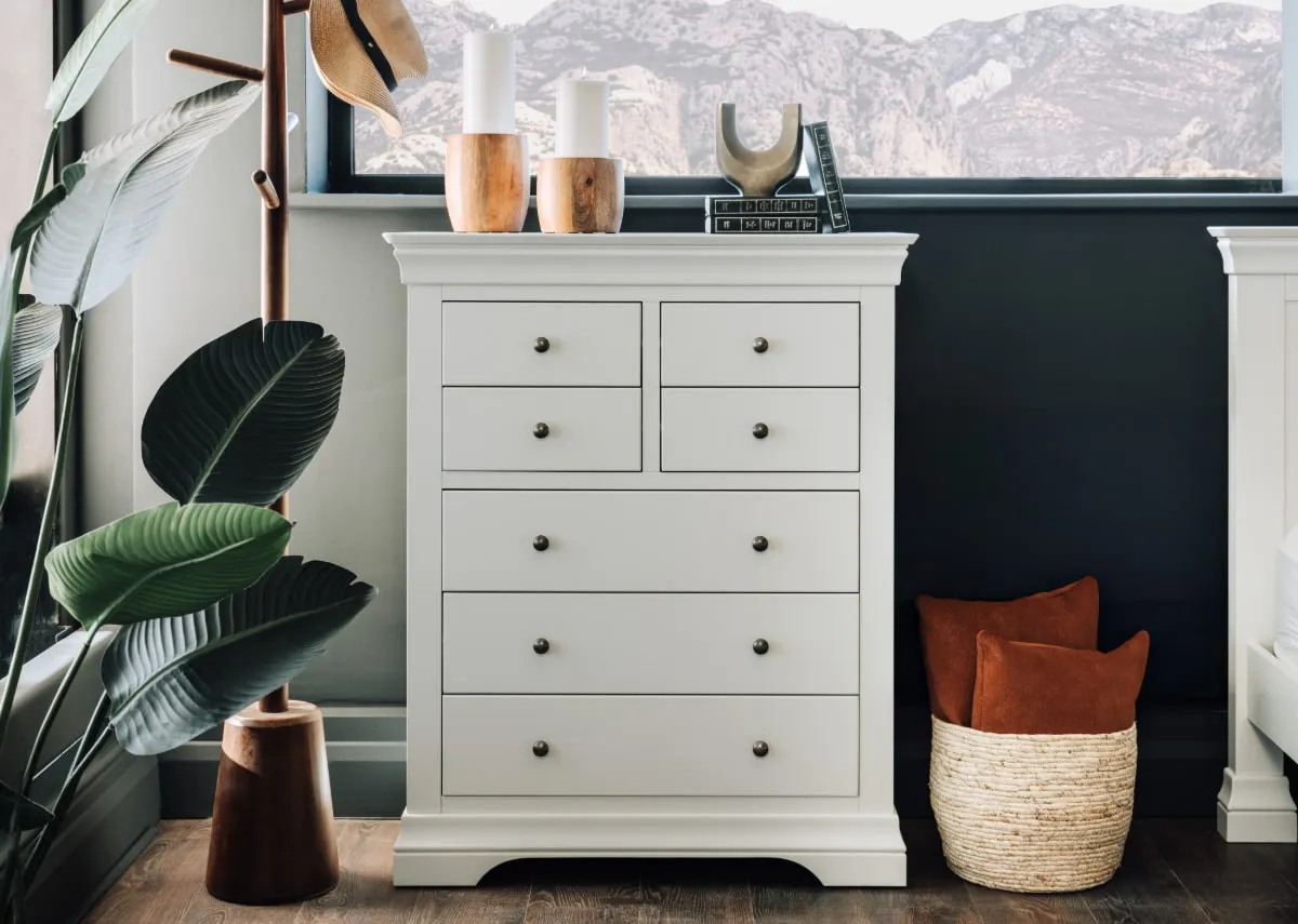 A lifestyle image of the Dove chest with coatrack and candle holders from EZ Living Furniture