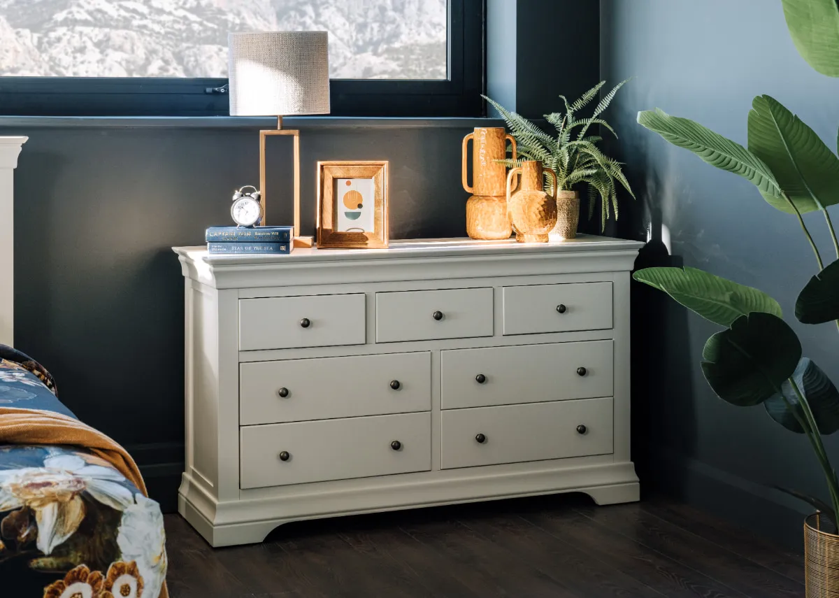 A lifestyle image of the Dove dresser with table lamp and a selection of light & living accessories