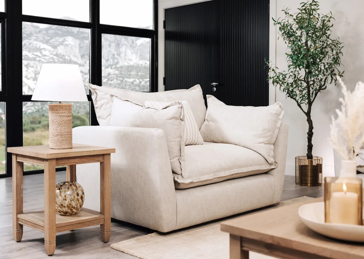 A lifestyle image of the Tara cuddler with Dawn lamp table