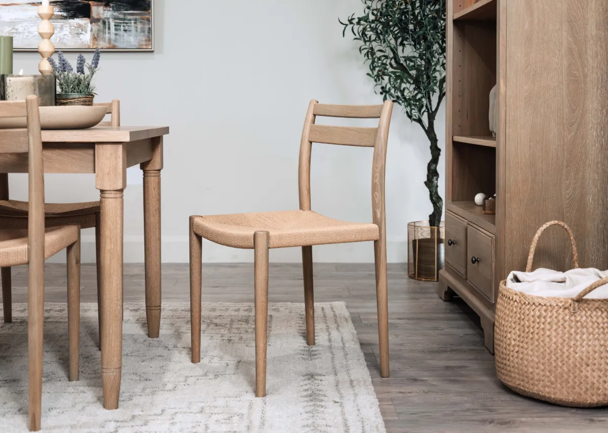 A lifestyle image of the Dawn dining chair with extendable table and bookcase with Nizza rug