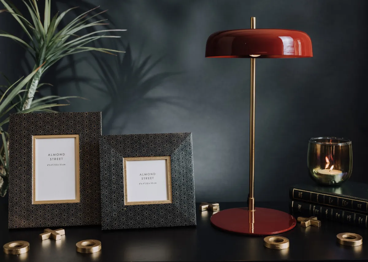 A lifestyle image of the Falmouth frames with Maleka lamp.