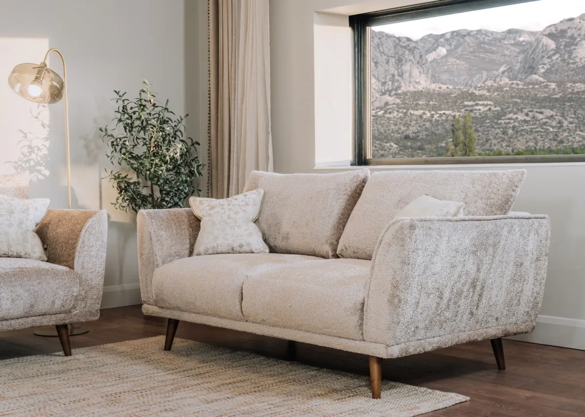 A lifestyle image of the Boutique sofa with Camila floor lamp