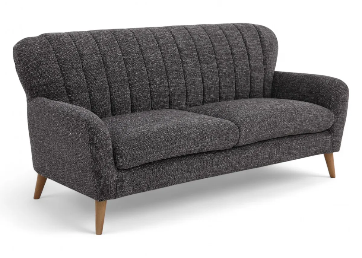 A dark grey 3 seater sofa from EZ Livings Harper range. Angled view of pleated back.