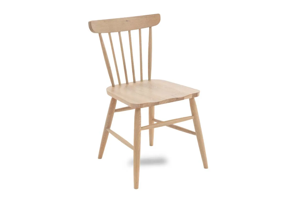 An oak dining chair with spindle curved back from EZ Living Furniture. Angled view
