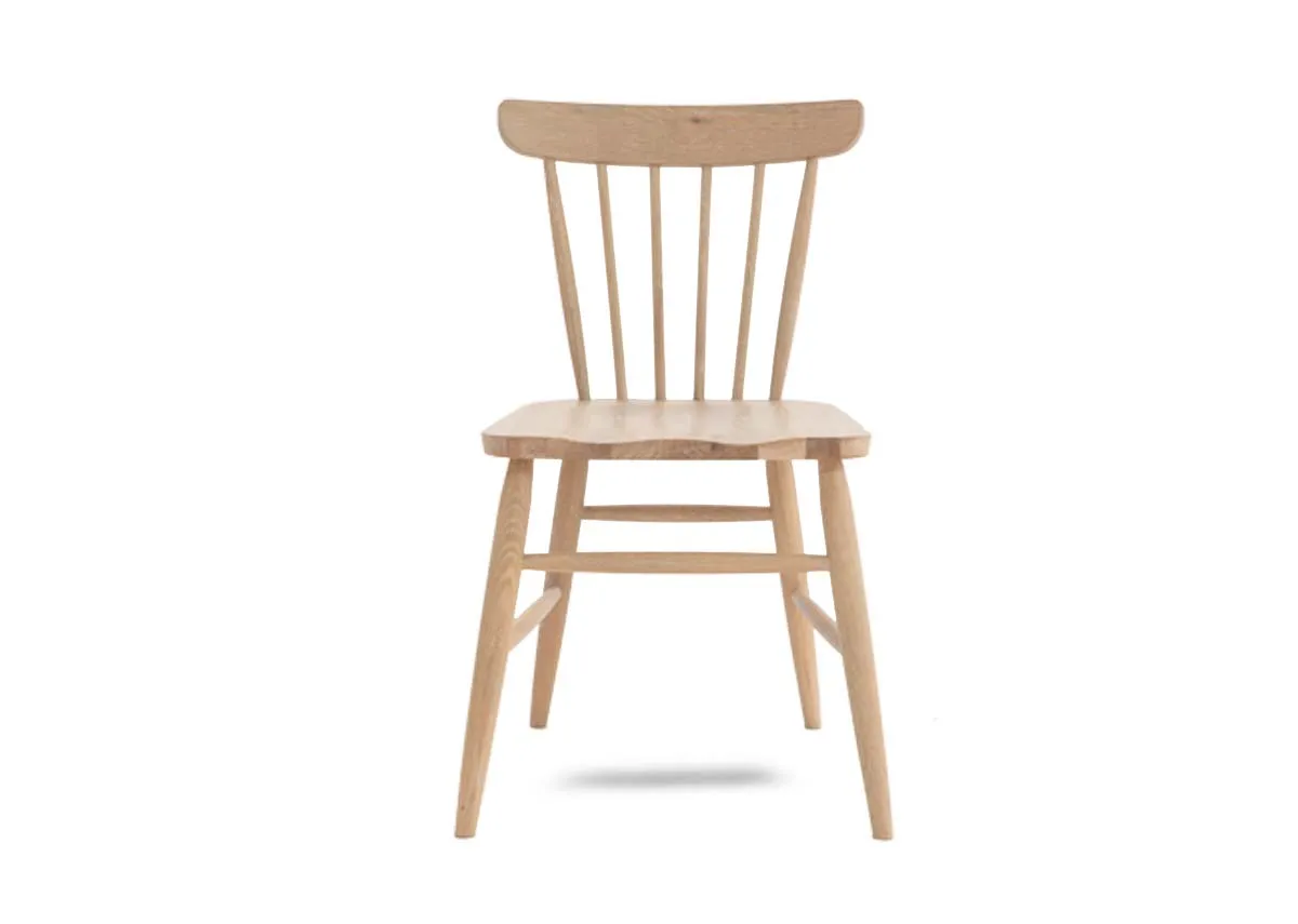 An oak dining chair with spindle curved back from EZ Living Furniture.. Front view