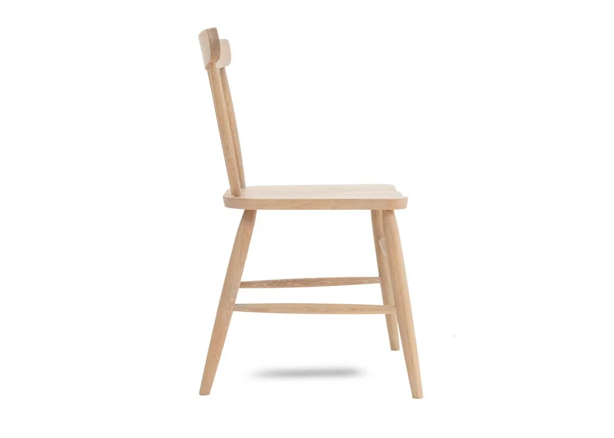 An oak dining chair with spindle curved back from EZ Living Furniture. Side view