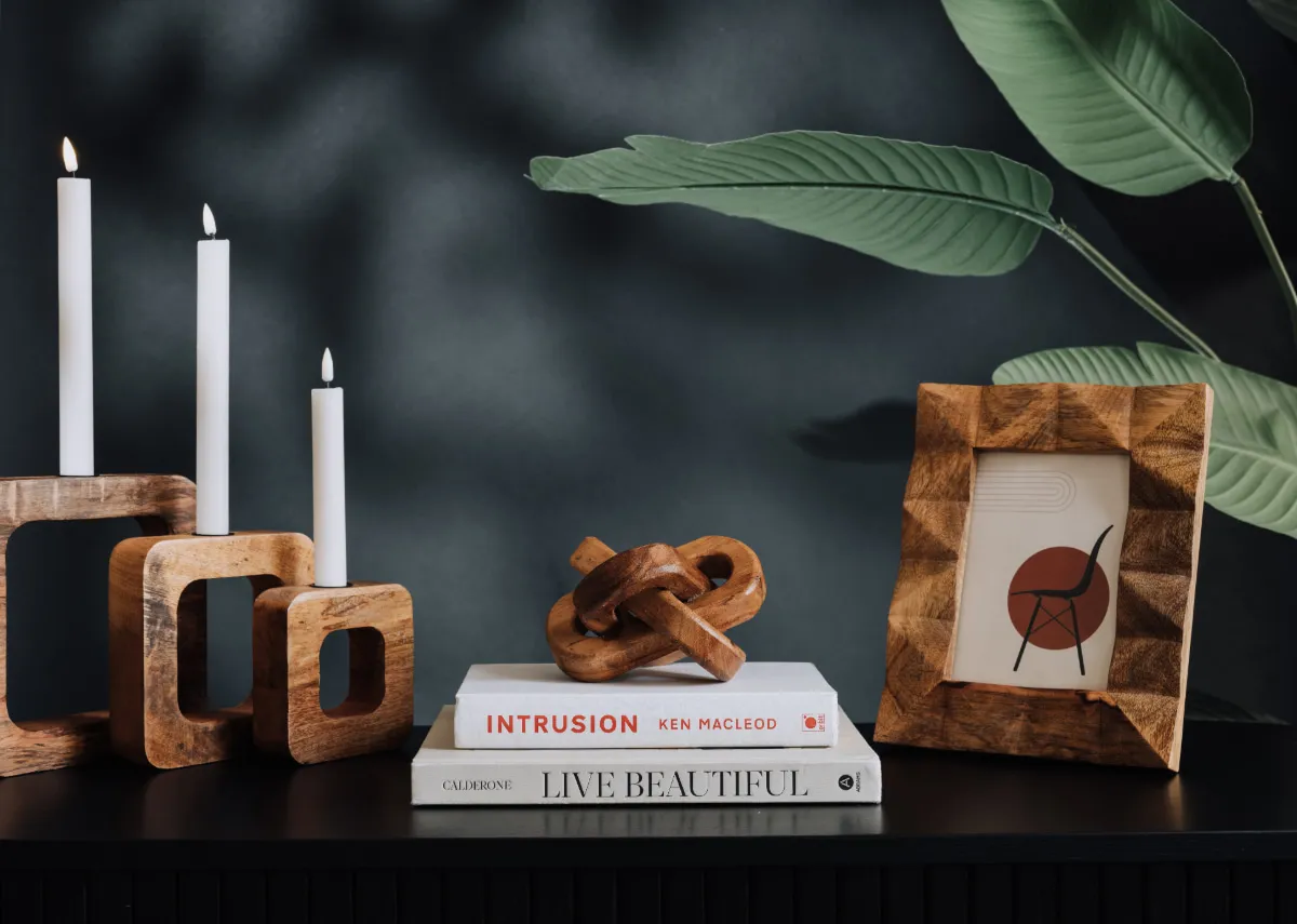 A lifestyle image of a selection of wood ornaments and frames including the Jada.