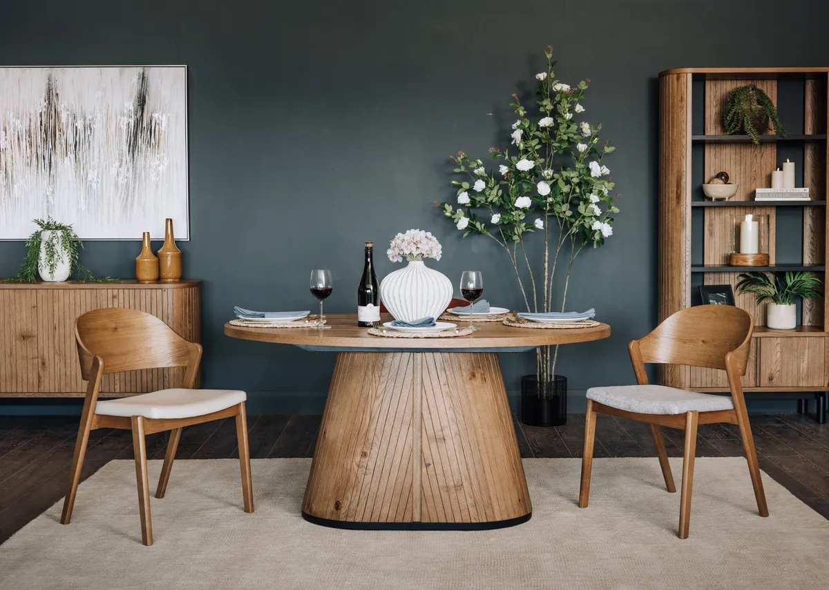 A lifestyle image of the Vega rustic table with chairs and Charleston rug