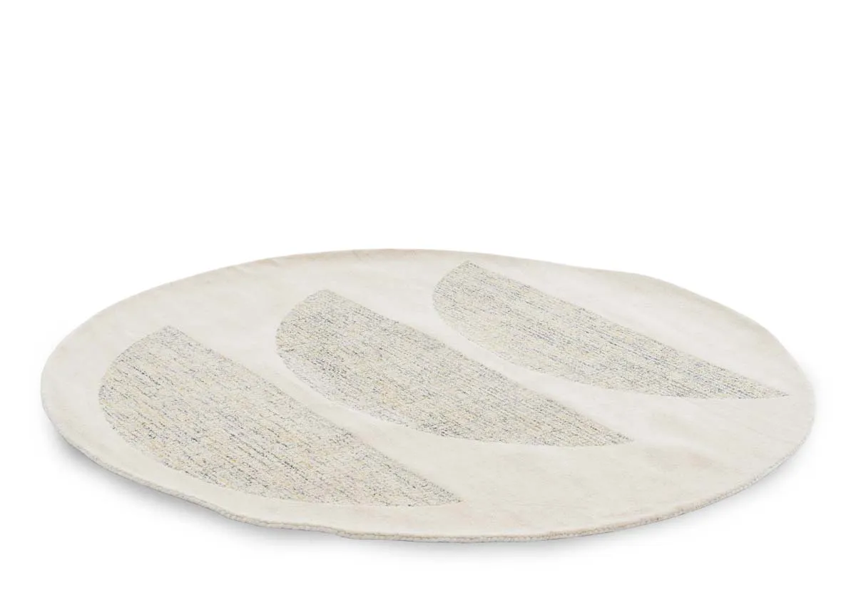 A round natural rug with 3 semi circle shapes in centre from EZ Livings Louisville range. Angled view of