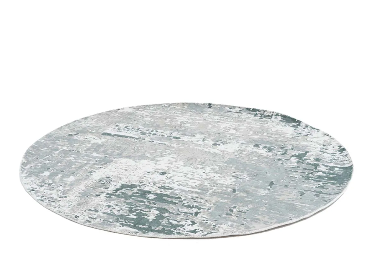 A round green and ivory rug from EZ Livings Modesto range.Angled veiw shows short pile