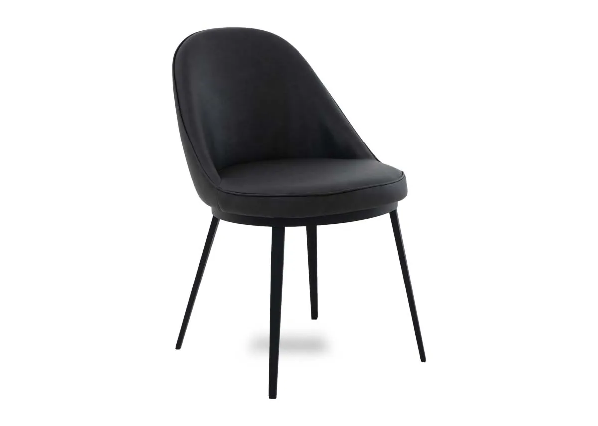 A dark grey dining chair from EZ Livings Gain range. Angled view of dark grey faux leather upholstery.
