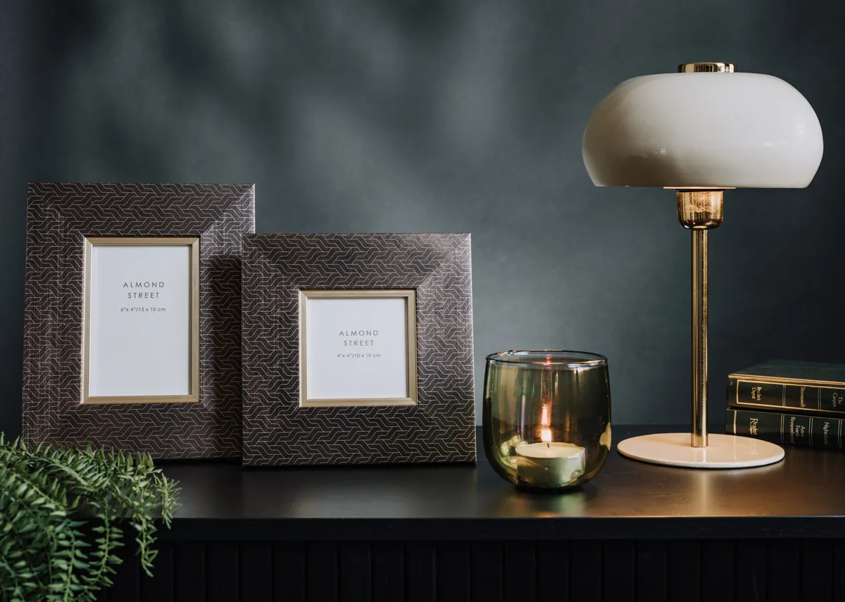 A lifestyle image of the Evesham frames and Surin lamp