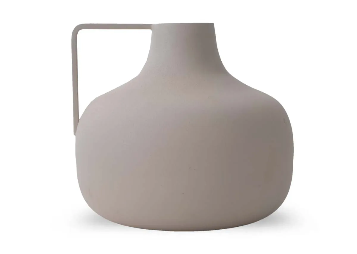 A medium sized rounded cream decorative item with a straight handle extending from the top left.