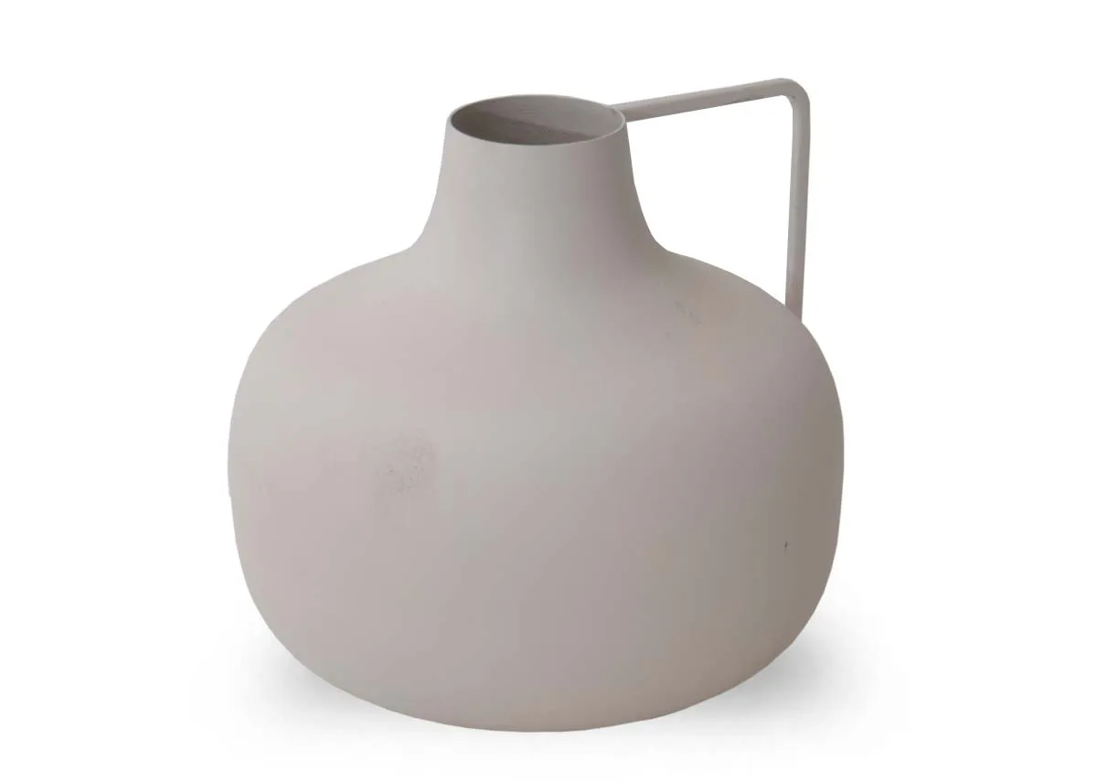 A medium sized rounded cream decorative item with a straight handle extending from the top right.