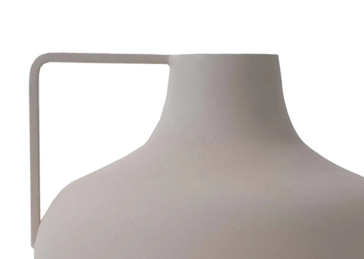 A close up of the straight rectangular handle on a medium sized rounded cream decorative item.