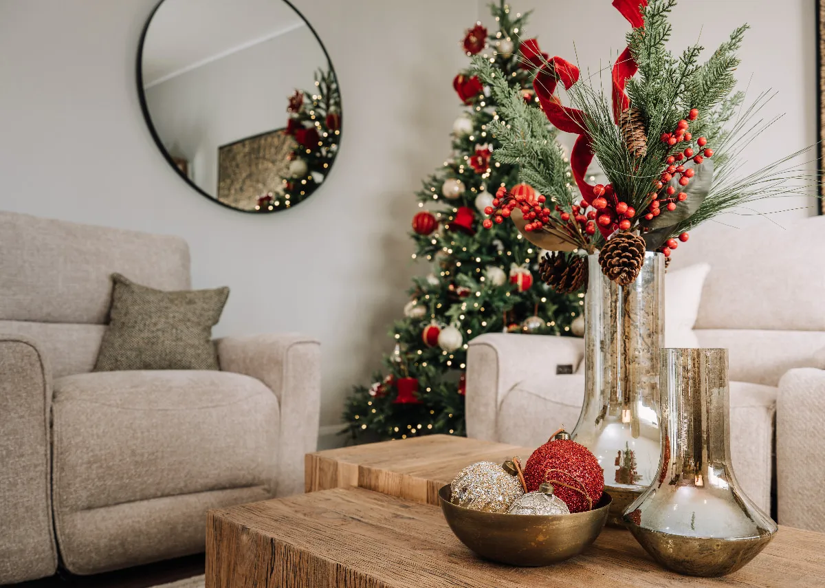 A lifestyle image of the Leanna Vase with sprays in a Christmas setting on a Nova coffee table with Ashbrook sofa