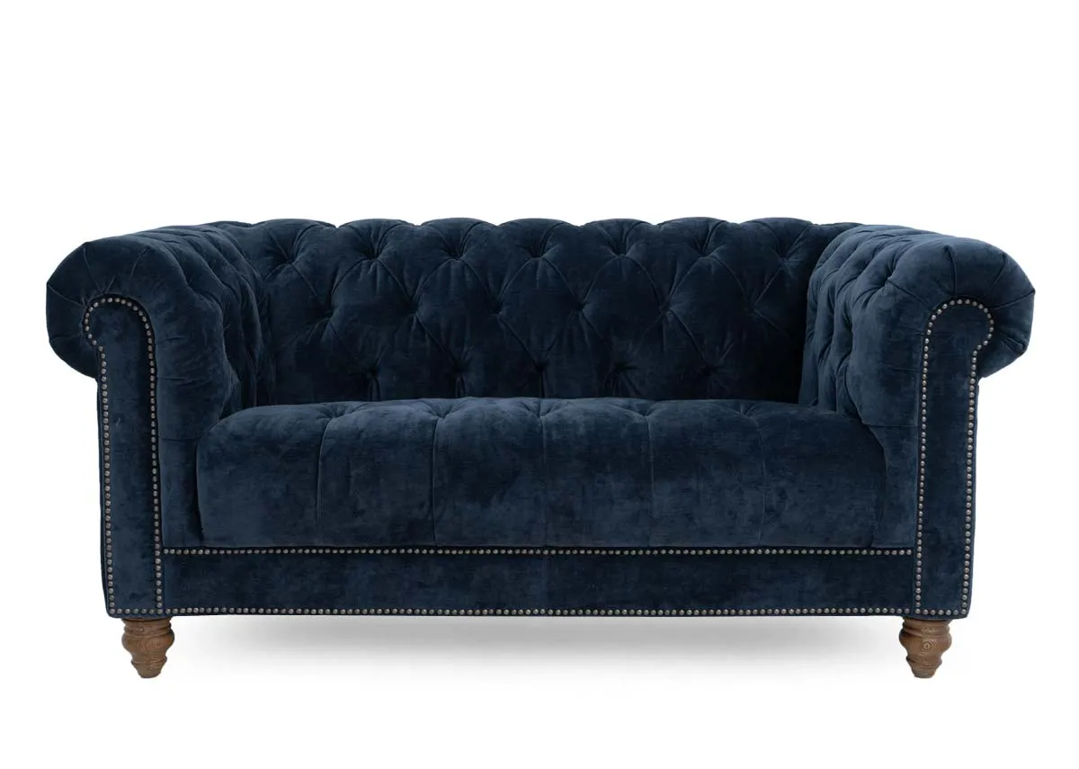 A 2 seater roll back sofa from EZ Livings Adare range. Front view of studded trim and ash feet