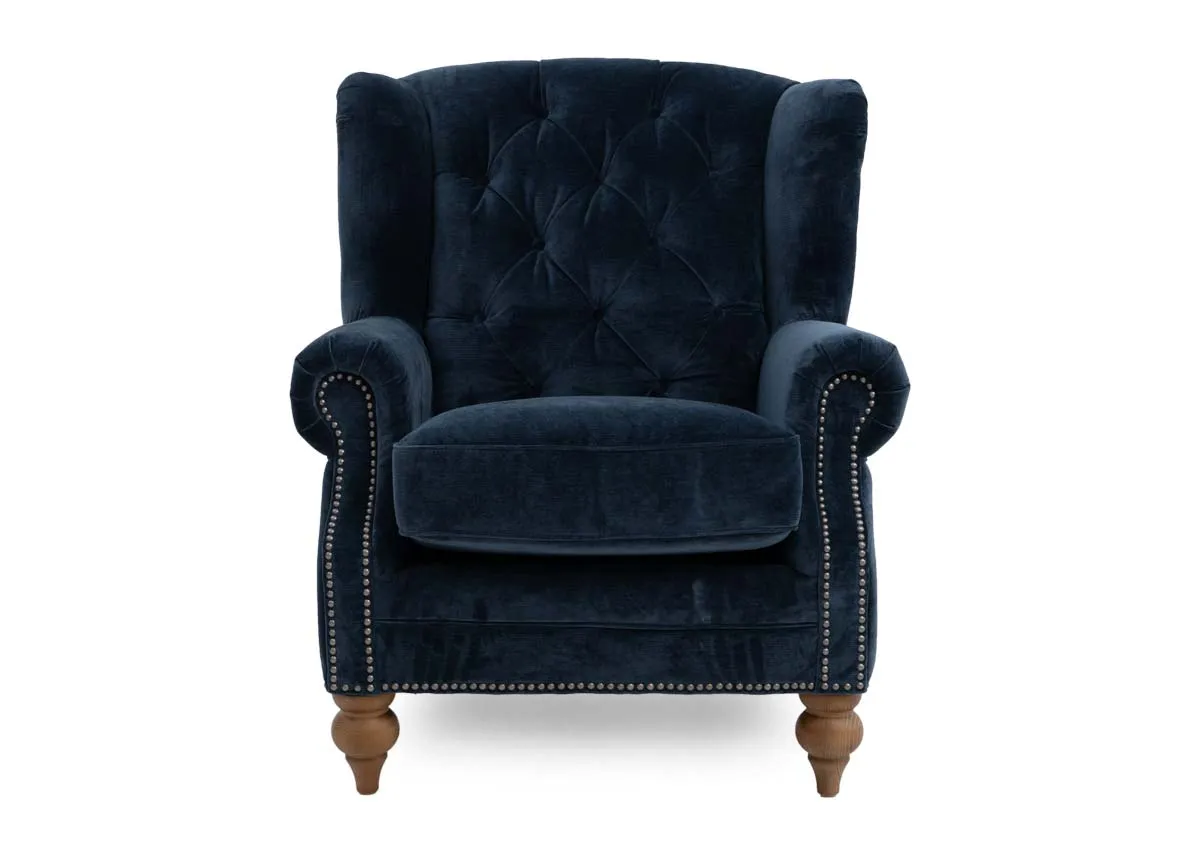 A blue fabric wing chair with stud detail from EZ Livings Adare range. Front view