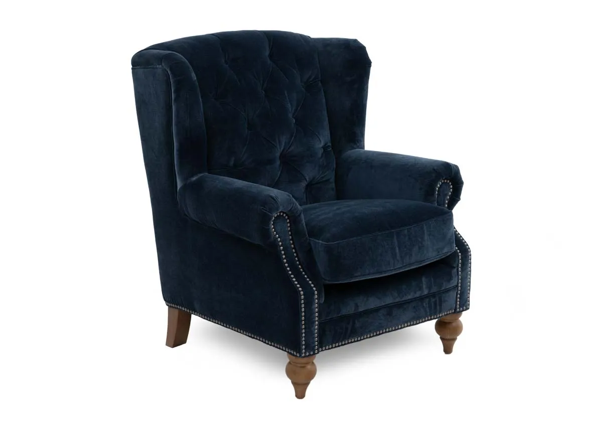 A blue fabric wing chair with stud detail from EZ Livings Adare range. Angled view