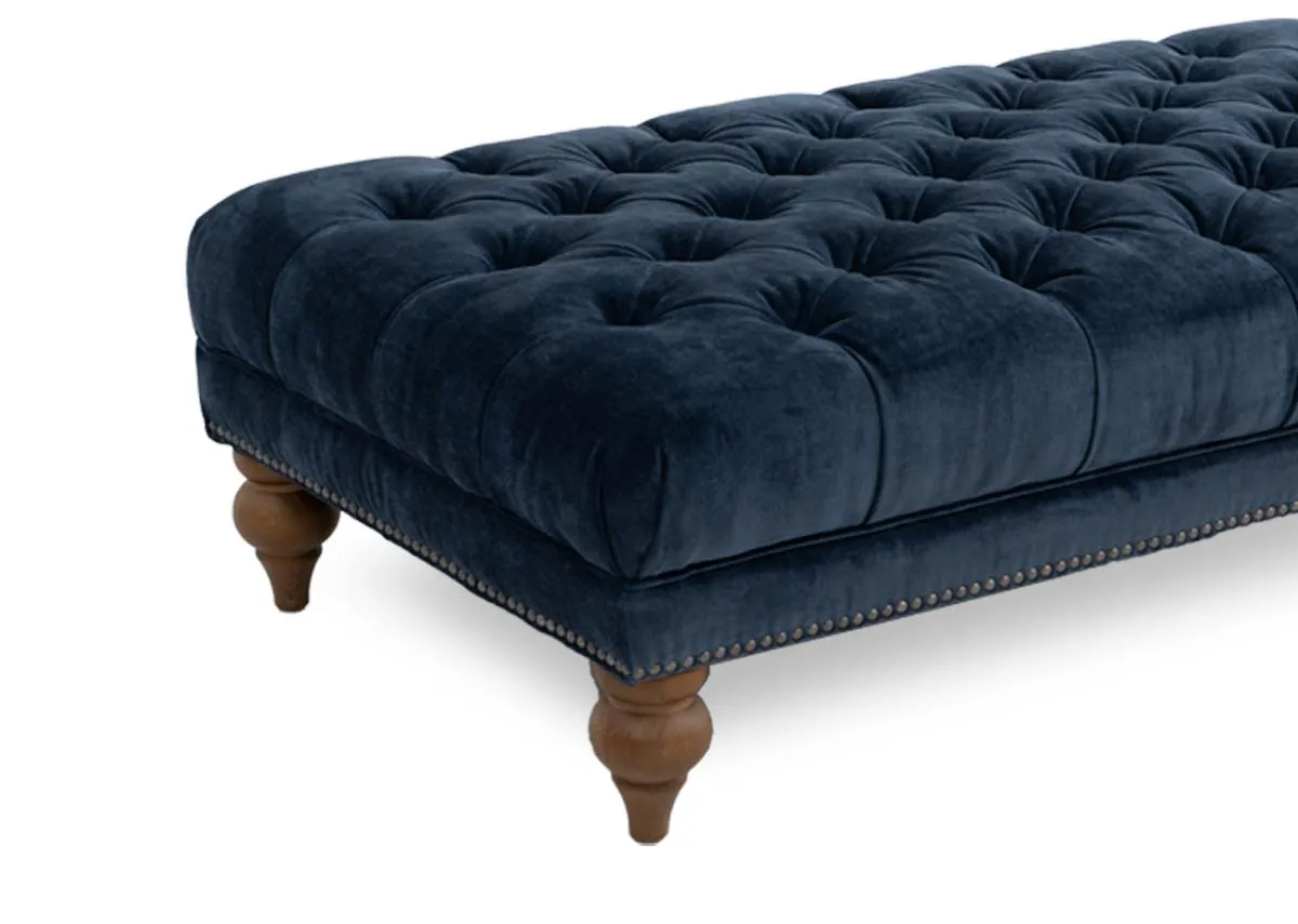 A blue fabric rectangular footstool from EZ Livings Adare range. Closeup of rich fabric