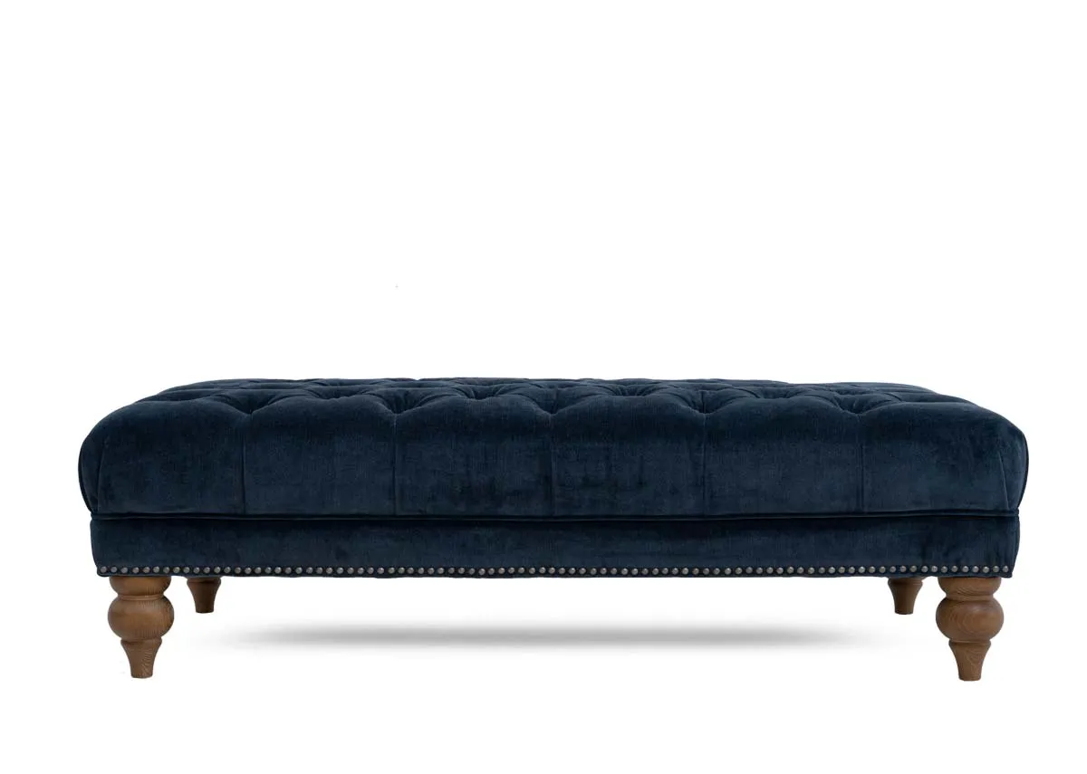 A blue fabric rectangular footstool from EZ Livings Adare range. Front view of long shape