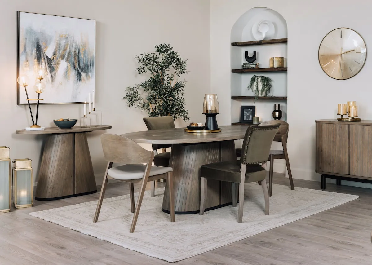 A lifestyle image of the Vega grey dining table and matching chairs with sideboard and console.