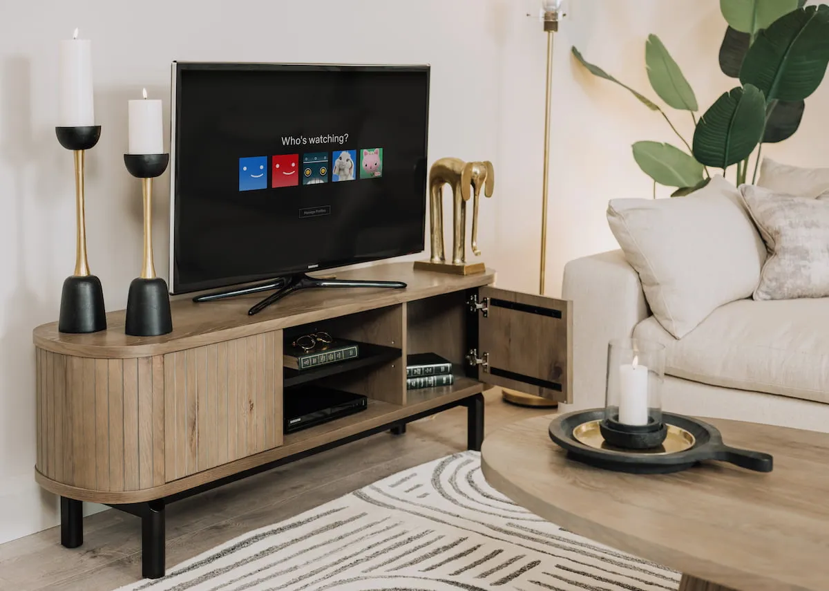 A lifestyle image of the Vega grey tv unit with door open showing space.