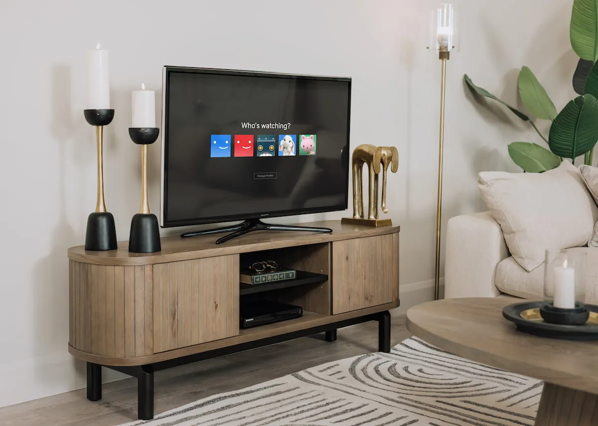 A lifestyle image of the Vega grey tv unit with doors closed and candleholders and elephant ornament.