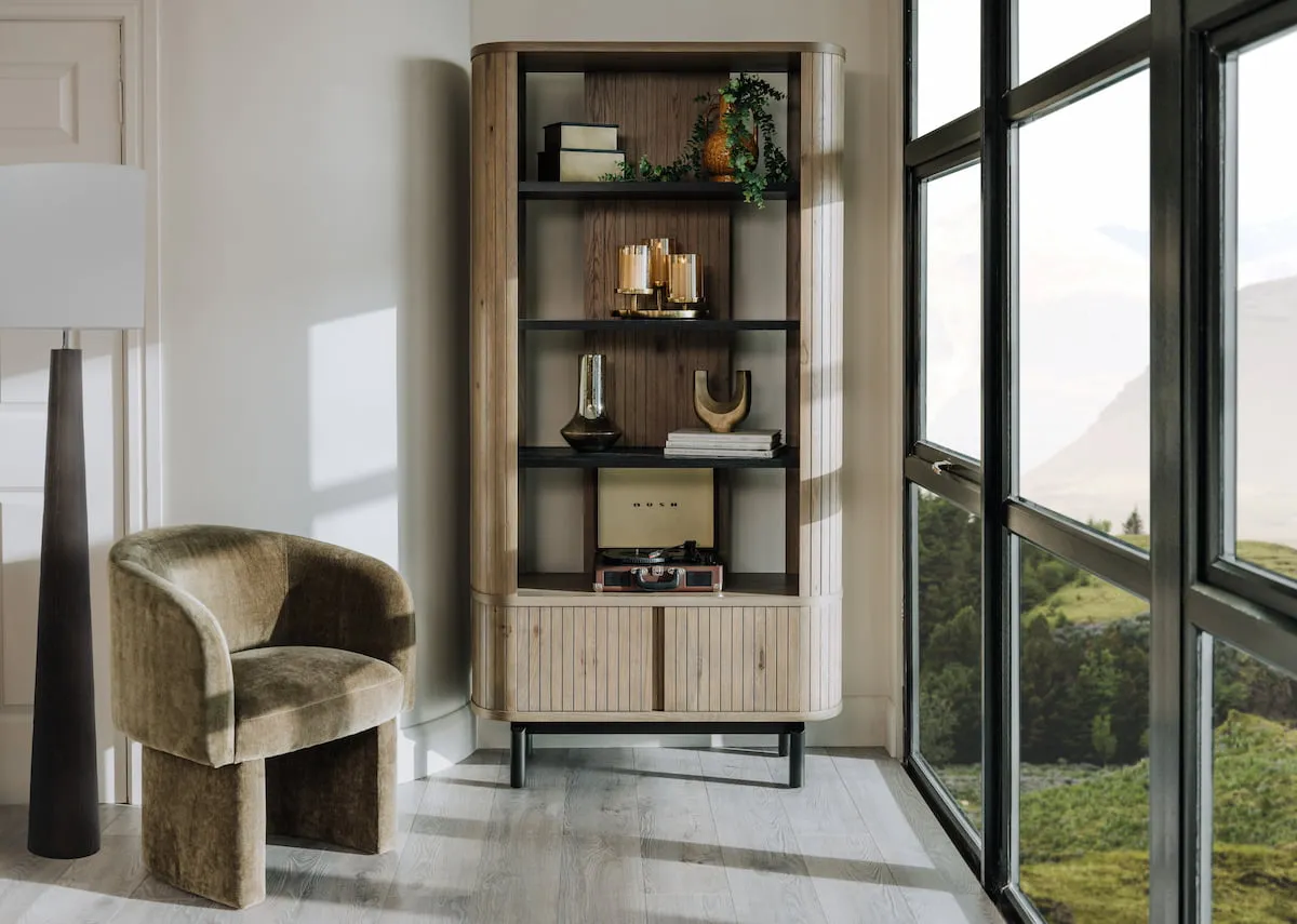 A lifestyle image of the Hope occasional chair with the Vega grey display unit filled with accessories