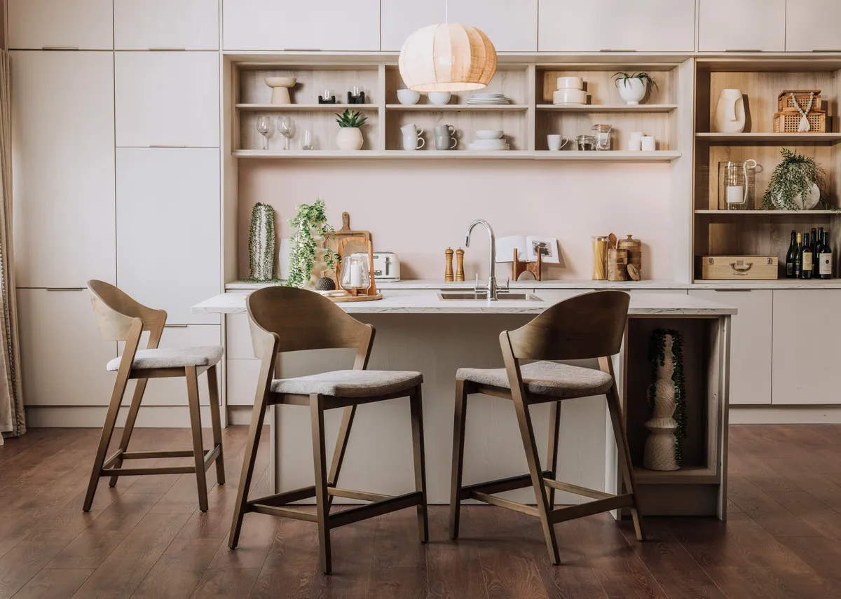 A lifestyle image of the Vega grey bar stools with fabric and leather padded seats.