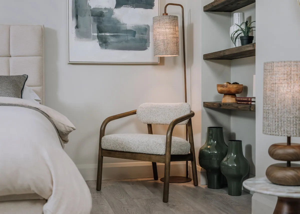 A lifestyle image of the Lewes chair with Elodie floor lamp and sindo vases.