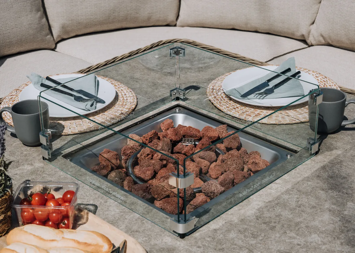 A lifestyle image of the Monterey Dining Table with a closeup of door for fitting gas cylinder